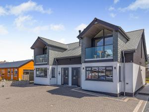 a large house with glass doors in a parking lot at Scilla - Uk50179 in Helston