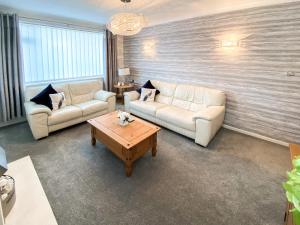 a living room with two couches and a coffee table at Berwick Lodge in Thornton