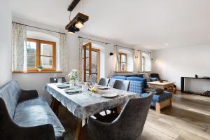 a living room with a table and a couch at Ferienhaus Region Tegernsee in Eben