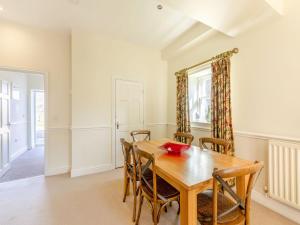 a dining room with a wooden table and chairs at Longlands - Uk49289 in Preston