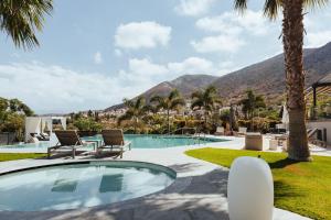 a villa with a swimming pool and palm trees at Orama Luxury Villa 4 Bedrooms with Private Pool in Hersonissos