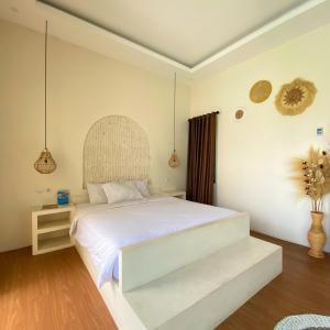 a bedroom with a large white bed in a room at Vikosa Villa Private Pool With View in Yogyakarta