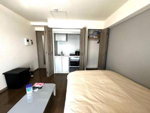 Ένα ή περισσότερα κρεβάτια σε δωμάτιο στο 9-5 NEW OPEN　美室駅近で眺望良好　駐車場予約可