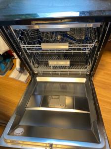 an empty dishwasher with its rack in it at Mango in Madinaty