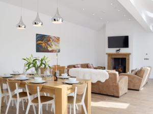 a living room with a table and a couch at Manor Lodge Stables in Wiston