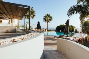 a view of the pool at a resort with umbrellas at Orama Luxury Villa 4 Bedrooms with Private Pool in Hersonissos