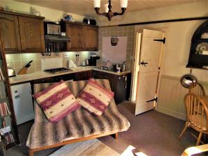 a kitchen with a couch with two pillows on it at Tigh Na Maraiche in Craighouse