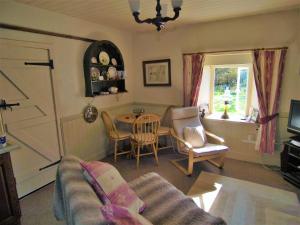 a living room with a couch and a table at Tigh Na Maraiche in Craighouse +12 photos