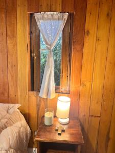 a bedroom with a table with a lamp and a window at YogaLife in Mercedes +3 photos