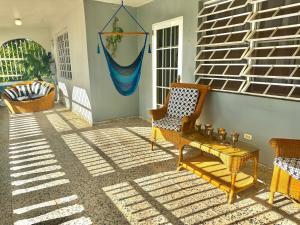 a living room with a chair and a table at Casa Nube in Cayey