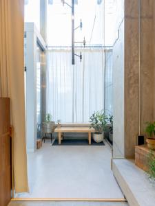 a room with a wooden bench and a large window at Hotel art rock in Takamatsu