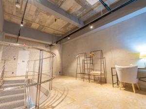 a room with a cage and a table and chairs at Hotel art rock in Takamatsu