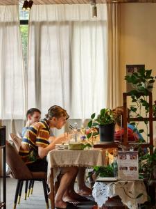 two men sitting at a table eating food at Guilin cozy mountain retreat in Guilin