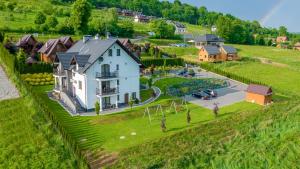 an aerial view of a house on a hill at Jaworina- Apartamenty, Domki i Pokoje in Solina