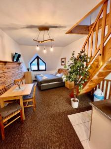 a living room with a couch and a table at Penzion Mona Rooms & Apartments in Harrachov