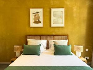 a bedroom with a bed with green and white pillows at Lorlagon by LOV Mauritius in Trou dʼ Eau Douce