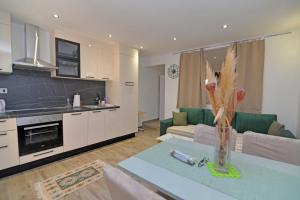 a living room with a couch and a table at LunaStela in Veli Lošinj