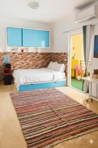 a bedroom with a bed and a large rug at Wavesong Whispers flat where you can enjoy seaview with the best price and enjoy speedy wifi in Hurghada