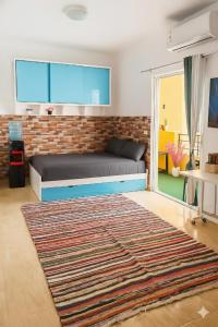 a bedroom with a bed and a brick wall at Wavesong Whispers flat where you can enjoy seaview with the best price and enjoy speedy wifi in Hurghada