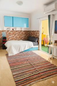a bedroom with a bed and a brick wall at Wavesong Whispers flat where you can enjoy seaview with the best price and enjoy speedy wifi for forigners only ممنوع المصريين in Hurghada +33 photos