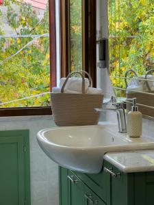 a bathroom with a sink and a window at Corte 'e Susu - Domo Experience in Ortueri