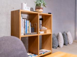 a book shelf filled with books in a living room at Hotel art rock in Takamatsu