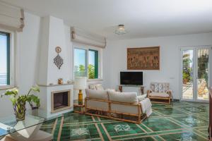a living room with a couch and a fireplace at POSEA Collection - Villa La Nice in Positano