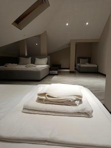 a bedroom with two beds with white blankets on the floor at Intercity Hotel Tashkent by Maskan in Tashkent +28 photos