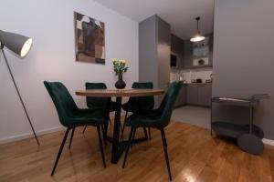 a dining room with a table and green chairs at Apartman Manči in Zaprešić +20 photos
