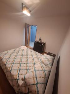 a bedroom with a large bed and a table at CasaLuxi in Alexandria +2 photos