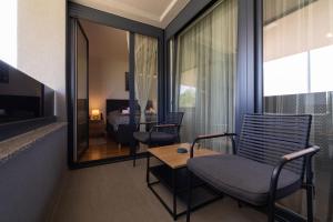 a room with a bed and a table and chairs at Apartman Manči in Zaprešić