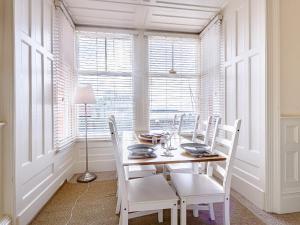a dining room with a table and chairs and a window at Apartment 1 - Uk32244 in Aberdyfi +21 photos