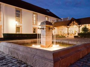 a water fountain in front of a building at Novotel Saclay in Saclay