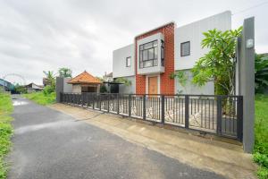 a fence in front of a house at Kragilan CoLiving By ARBA in Jetis