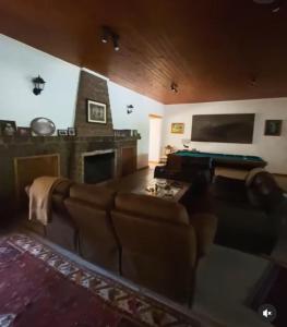 a living room with a couch and a pool table at Hacienda Ranguil in Lolol
