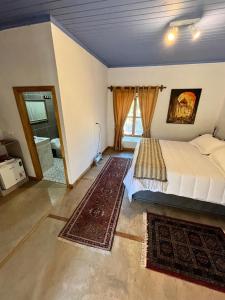 a bedroom with a bed and a large window at Hacienda Ranguil in Lolol