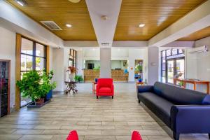 a lobby with a couch and a red chair at Motel 6 Birmingham, AL - Medical Center - Inverness Hwy 280 in Birmingham