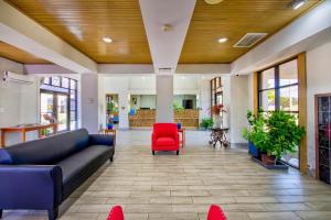 a lobby with a couch and a red chair at Motel 6 Birmingham, AL - Medical Center - Inverness Hwy 280 in Birmingham