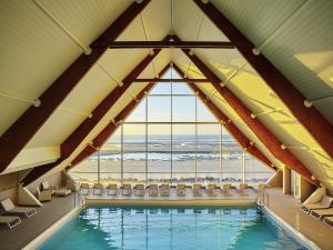 a pool in a room with a large window at Novotel Thalassa Le Touquet in Le Touquet-Paris-Plage