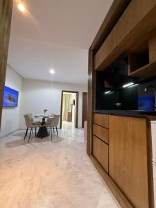 a living room with a dining table and a large television at Facelift in Tangier +79 photos