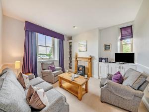 a living room with two couches and a tv at Doxford House - Uk49888 in Preston