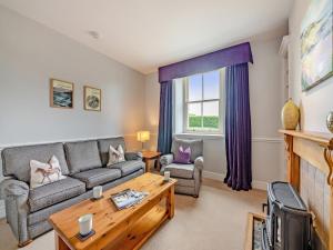 a living room with a couch and a table at Doxford House - Uk49888 in Preston