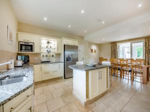 a kitchen with white cabinets and a counter top at Doxford House - Uk49888 in Preston +21 photos