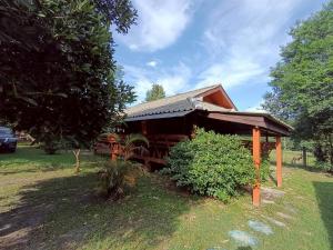 a small house in a field with a tree at Doisaket hills in Doi Saket