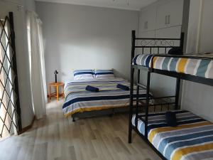 two bunk beds in a room with a hallway at Bedrock inn in Harrismith