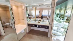 a bathroom with two sinks and a large mirror at Argentino Hotel in Mar del Plata