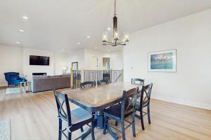 a dining room with a table and chairs at Lake Goodwin Retreat in Lake Goodwin