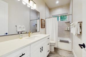 a white bathroom with a sink and a toilet at Lake Goodwin Retreat in Lake Goodwin +11 photos