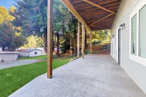 an empty porch of a house with a roof at Lake Goodwin Retreat in Lake Goodwin