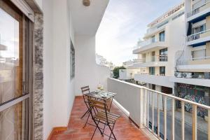 a balcony with two chairs and a table at Happy House Central Apartment in Faro